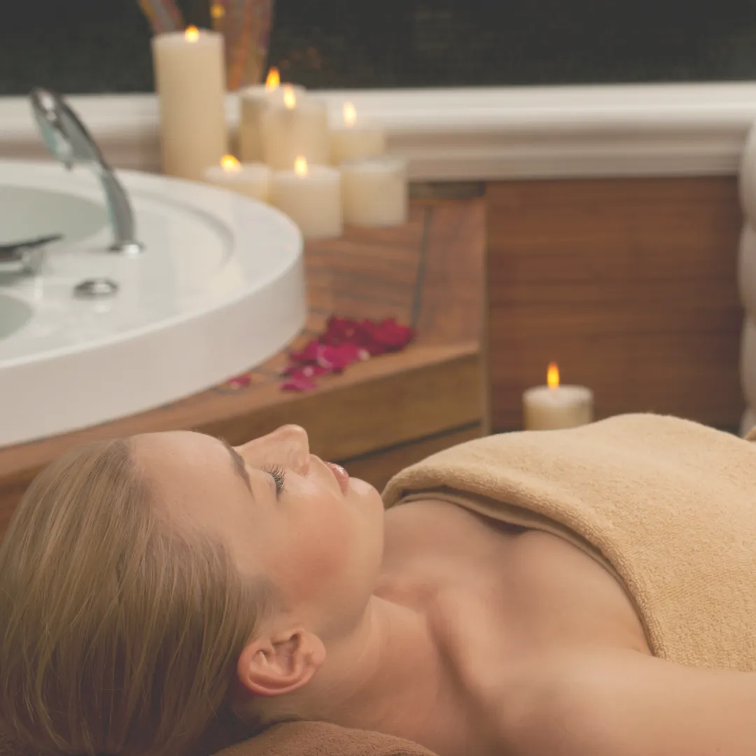 A client in a state of deep relaxation during a spa treatment, illustrating the high-value patient experience and satisfaction that drives client retention and successful care plan conversions.